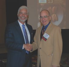 NPSA President Marty Harrell, left, thanks Warren Stone of the Grocery Manufacturers Association for his presentation at the NPSA meeting.