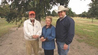Pat and Marguerite Baggett took home the Grand Champion Commercial Pecan award in the Texas State Pecan Show held in July. At right is their Washington County Extension agent Larry Pierce. (Photo by Monte Nesbitt)
