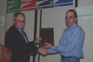 Roger Hooper, left, presented a posthumous award from WPGA to Jim Bennett for his contributions to the pecan industry. Accepting the award was Bennett’s son, Bobby Bennett of Fort Stockton, Texas. (Photo by Cindy Wise)