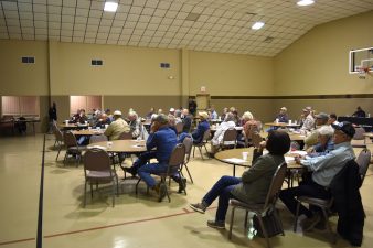 In an auditorium in Goldthwaite, Texas, about 30 pecan growers and enthusiasts listen to a speaker at the Central Texas Pecan Short Course.