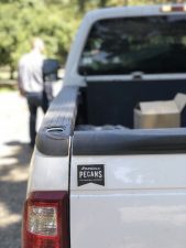 Back of a truck with a decal of the American Pecans logo