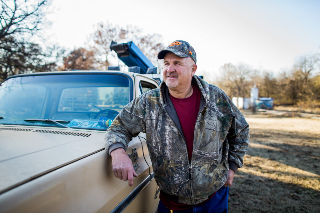 Pecan grower Martin Mount stands next to his pick-up.