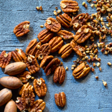 Pecans from shell to pieces laid artfully on a counter. USDA's CFAP 2 will provide direct assistance to pecan growers and businesses impacted by the pandemic.