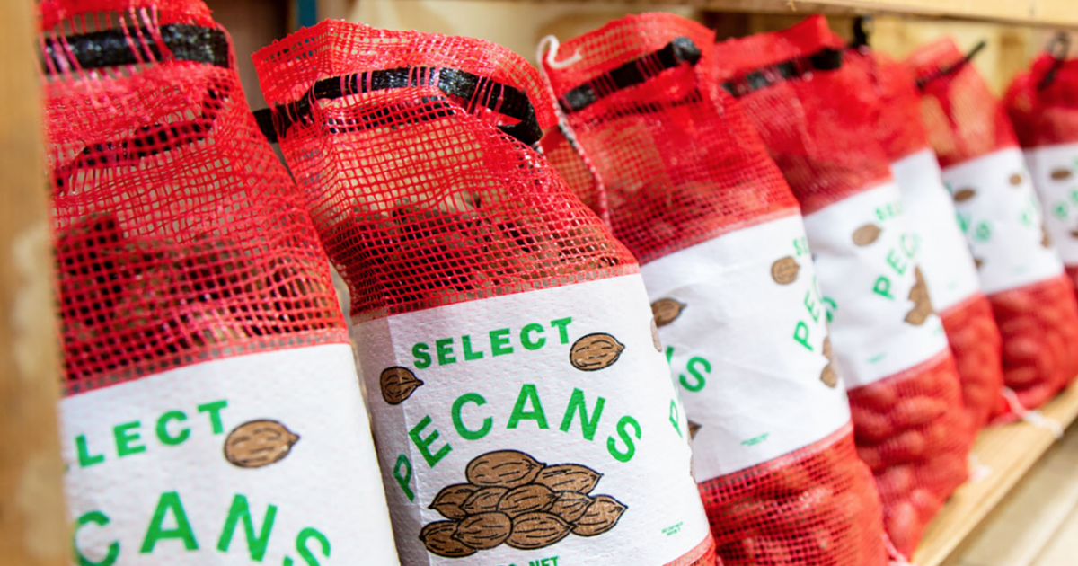 Bagged pecans sit in a line on the bottom of a wooden shelf. The new pecan research and promotion program has the authority to collect assessments for domestic and foreign grown pecans imported into the U.S. USDA announced the industry members on the new APPB
