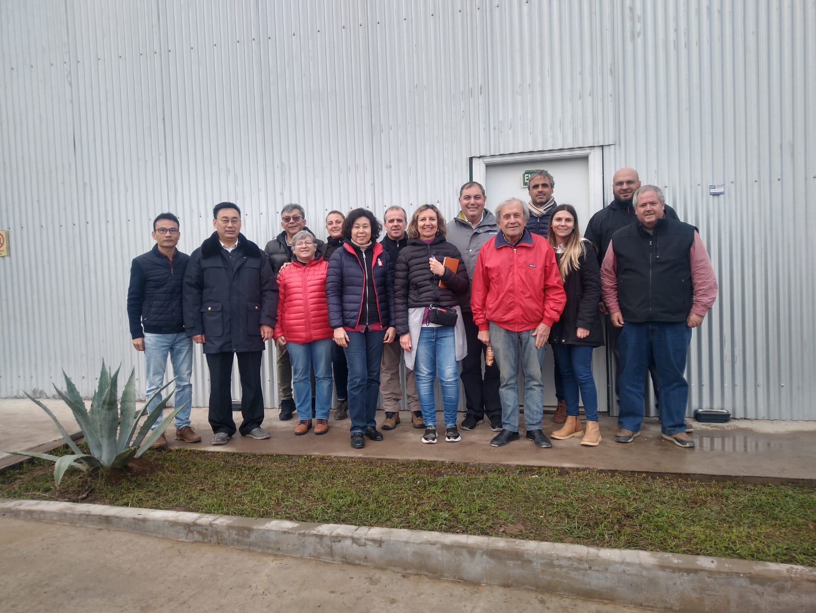 A group of representatives from China gather for a group photo outside of a pecan processing facility in Argentina.