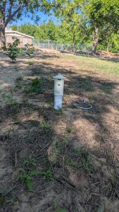 Figure 3. Aerosol emitters placed toward the upwind edge of an orchard can be programmed to dispense appropriate pheromones at regular intervals throughout the season. (Photo by Kristen Bowers)